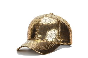 Close-up of golden PU leather baseball cap featuring black hexagonal honeycomb texture