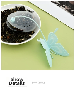 Macro shot of light blue butterfly silicone tea infuser with mesh bag for loose tea leaves