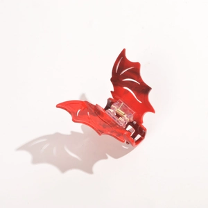 Detail of red marble texture acetate bat hair claw with golden spring and durable hinge