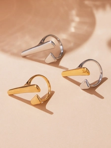 Three minimalist geometric open rings in gold, silver, and dual-tone polished finishes