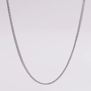 Detailed close-up of a classic silver chain link necklace in polished stainless steel