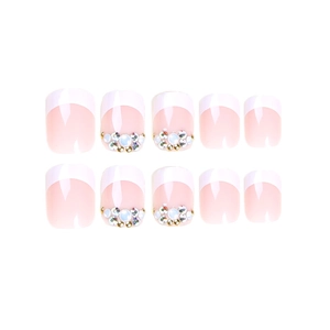 Short French press on nails in nude pink with white tips and elegant rhinestone accents