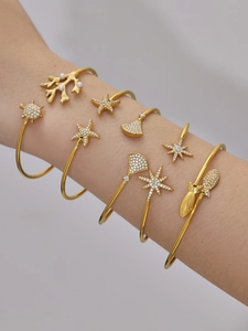 Détail de joncs dorés 18 carats avec motifs marins, tortues, étoiles et perles fines