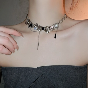 Detail of silver-tone punk choker with butterfly, star, and heart charms on model