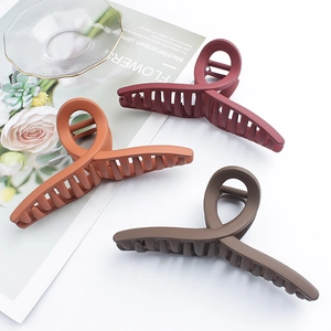 Three matte twisted shark hair claws in burgundy, orange, and brown for elegant styling