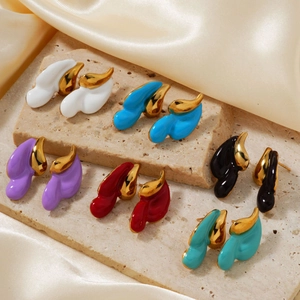 Colorful drop-shaped enamel earrings in vintage gold-plated finish on stone background