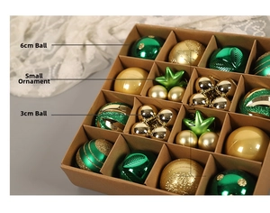 Close-up of green and gold Christmas ornaments in a 16-grid storage gift box