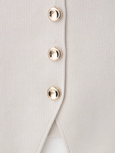 Close-up of beige knit fabric featuring three premium round gold metal buttons on the placket