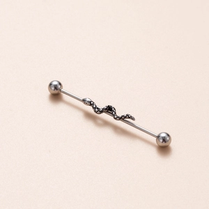 Macro shot of silver industrial barbell earring with detailed snake motif wrap
