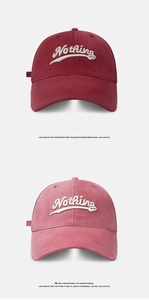 Detail of burgundy and rose pink brushed cotton baseball caps with Nothing embroidery