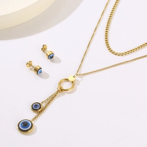 Golden double-layer evil eye necklace and stud earrings set with blue enamel details