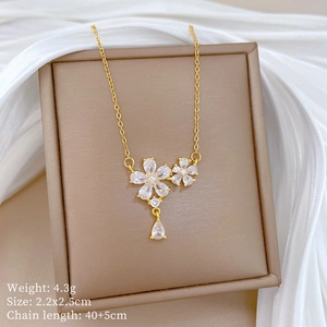Close-up of gold flower necklace with rhinestones on a brown jewelry box with silk