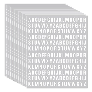 Close-up of 10 sheets of white sans-serif letter stickers for labeling and journaling