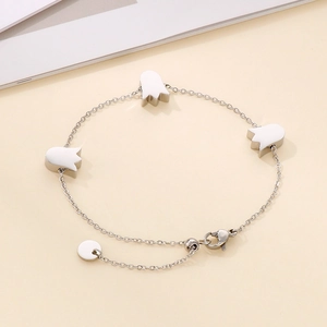 Close-up of silver steel chain bracelet featuring three minimalist tulip pendants