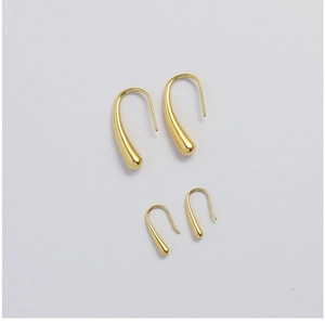 Macro view of water drop earrings in two sizes with polished 18K gold finish