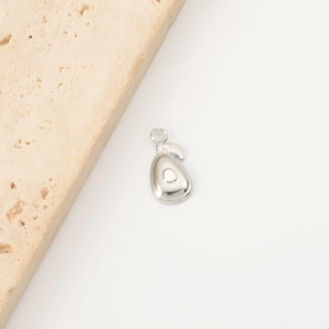 Detailed view of silver stainless steel avocado charm with polished finish and jump ring