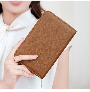 Detailed close-up of brown litchi grain leather wallet with high-quality metal zipper