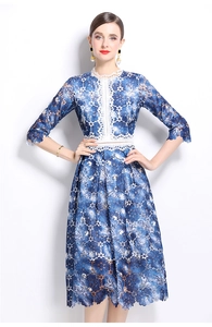 Detail of blue floral lace dress with white hollow embroidery and intricate patterns