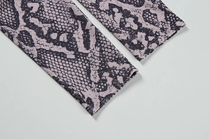 Detail view of purple snakeskin leggings featuring high-quality flatlock seam stitching