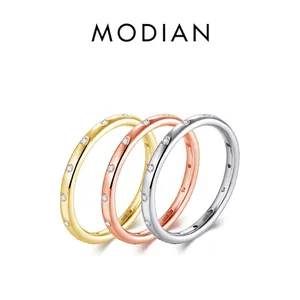 Three minimalist S925 sterling silver bands in silver, gold, and rose gold with pavé stones