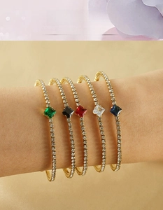 Detail of 18K gold-plated stainless steel bangles with colorful zircon stones on a wrist