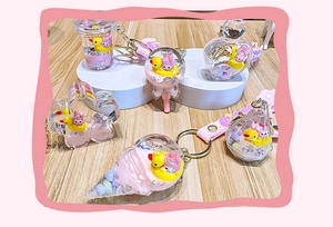 Detail of liquid quicksand keychain charms in shapes of boba cups and ice cream cones