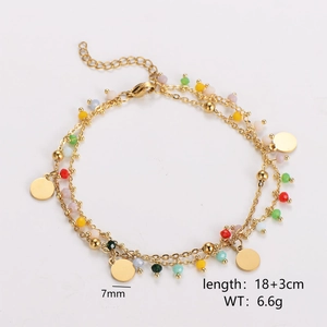 Detailed close-up of double-layer gold chain bracelet with colorful beads and coin charms