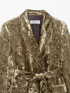 Detail of velvet blazer lapel and waist tie with metallic floral embroidery pattern