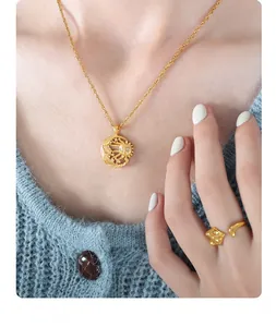 Detailed view of sun and moon pendant necklace with matching ring on knitwear
