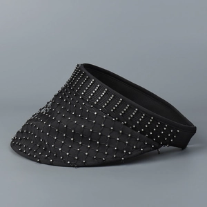 Close-up of black mesh sun hat featuring sparkling rhinestones and elegant knit texture