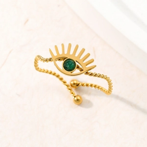 Adjustable gold twisted rope ring featuring a green natural stone evil eye charm