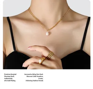 Detail view of double layer titanium steel necklace with gold plating and baroque pearl