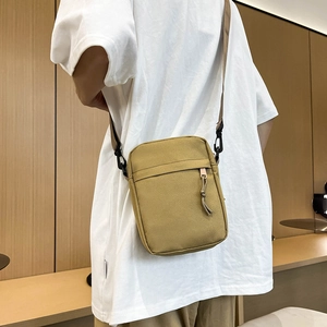 Minimalist bright yellow canvas crossbody bag for men featuring an adjustable strap