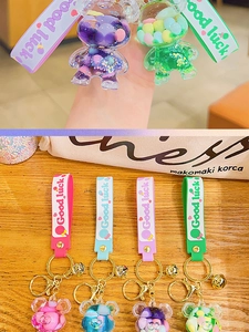 Detailed view of macaroon colored bear liquid keychains with silicone wristbands