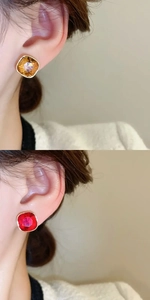 Detail view of 18K gold plated square earrings with sparkling brown and red gemstones