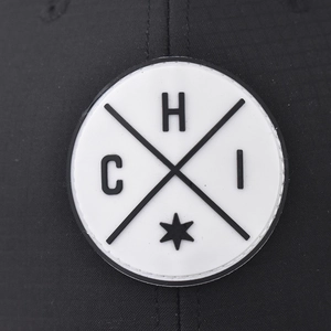 Deep-fit black plaid trucker hat with a vintage round patch and embroidery detail
