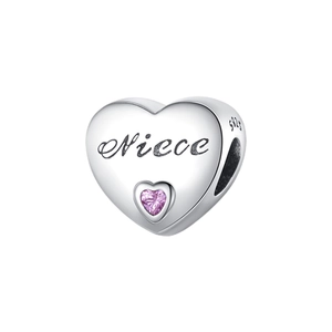 Macro detail of S925 sterling silver heart bead with Niece engraving and pink gem