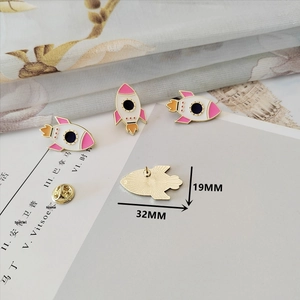 Detailed view of pink rocket enamel brooch with butterfly clasp and 32mm size marking