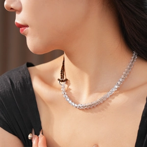 Close-up of sparkling zircon crystal beaded necklace worn by a model in soft light