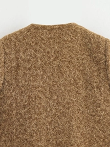 Close-up of camel fuzzy faux fur vest showing texture on the back and neckline area