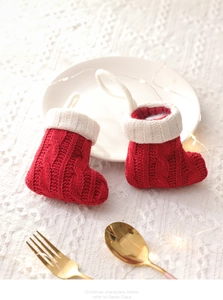 Close-up of red and white knit Christmas stockings used as decorative cutlery holders