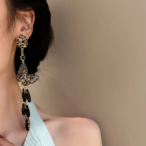 Vintage gold earrings with black crystal butterflies and tassel droplets worn by model