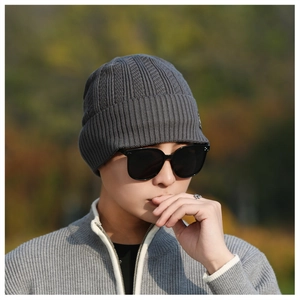 Detail of dark grey winter knit hat and matching zip cardigan for men outdoor