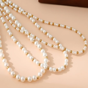 Elegant multi-layer necklace with lustrous white pearls and golden stainless steel beads