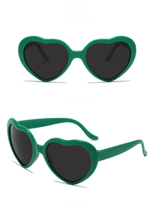 Close-up of heart-shaped dark green sunglasses showing front and side views clearly