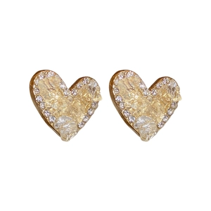 Elegant gold heart earrings with yellow crystal and white diamond border on white background