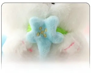 Close-up of soft white plush fabric and yellow star embroidery on the cat toy
