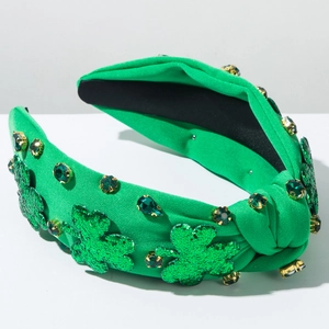 Macro detail of St. Patrick's Day headband with green sequins and rhinestone clovers