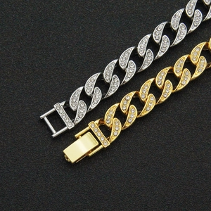 Iced out Cuban link bracelets in gold and silver finish with rhinestones on black background