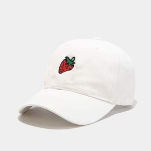 Close-up of strawberry embroidery detail on white cotton sun protection baseball cap
